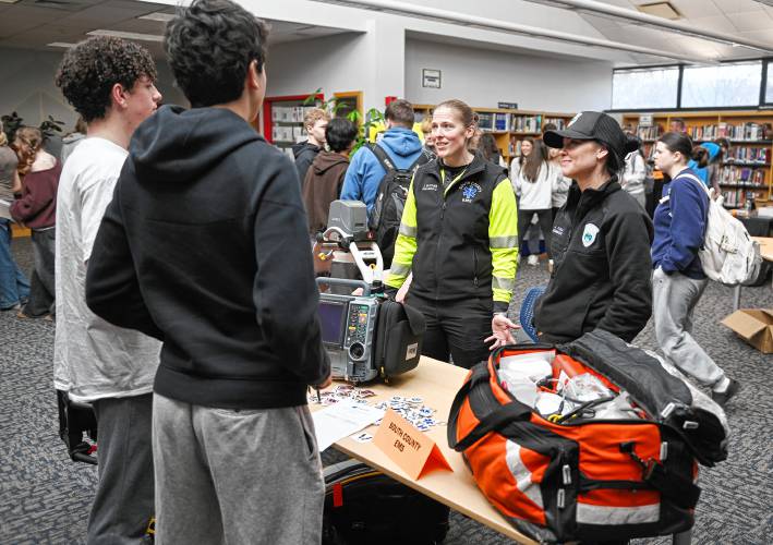 Frontier Regional School students talk with paramedics Laurie McComb and Alicia Toia of South County EMS during the Frontier Career Fair in the Media Center last week.