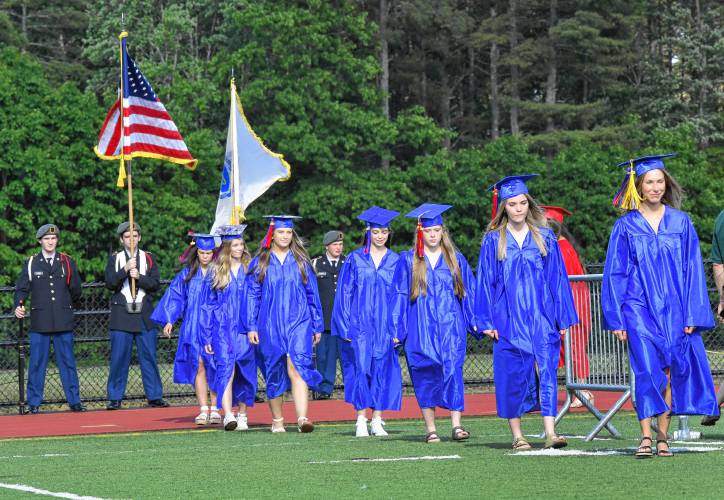 Seniors at Ralph C. Mahar Regional School process onto the athletic field for graduation on Friday in Orange.