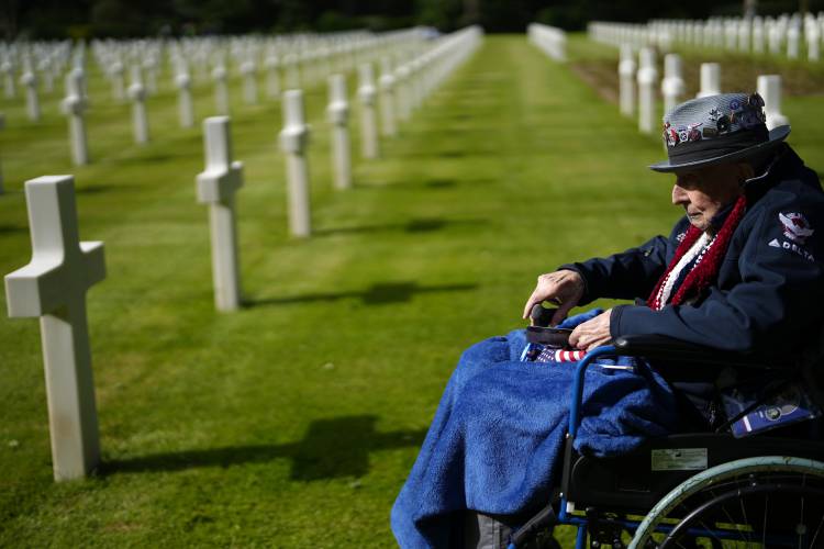 World War II and D-Day veteran Jake Larson visits the grave of a soldier from his unit at the Normandy American Cemetery in Colleville-sur-Mer, France, Tuesday, June 4, 2024. World War II veterans from across the United States as well as Britain and Canada are in Normandy this week to mark 80 years since the D-Day landings that helped lead to Hitler’s defeat.