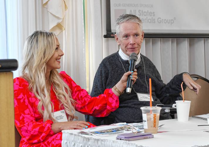 Jessye Deane, executive director of the Franklin County Chamber of Commerce, holds the microphone for Jeffrey Baker of Baker Financial Group as he speaks at the Franklin County Chamber of Commerce breakfast at Terrazza Ristorante in Greenfield Friday morning.