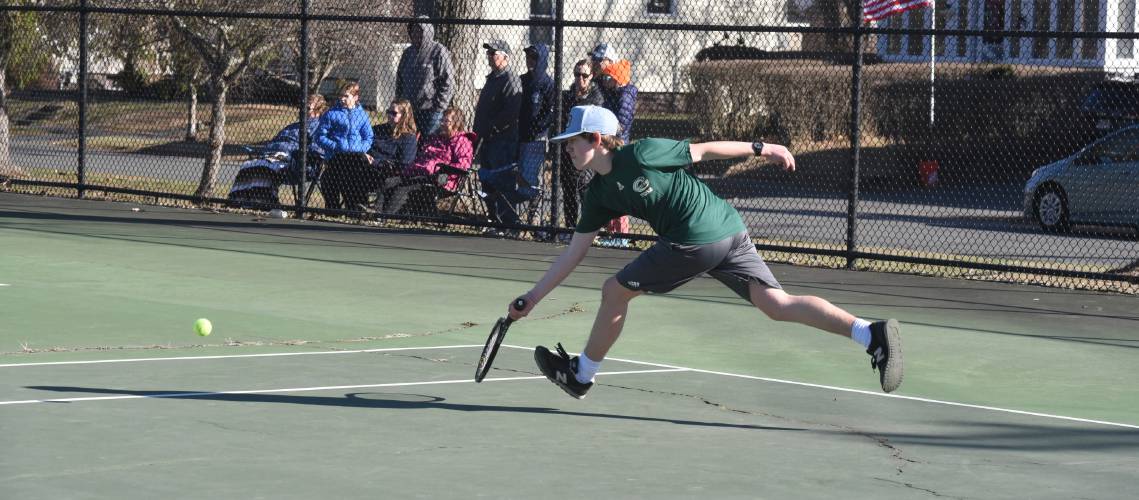 Greenfield's Noah Chambers reaches for a ball against SICS at the Davis Street Courts earlier this spring.  