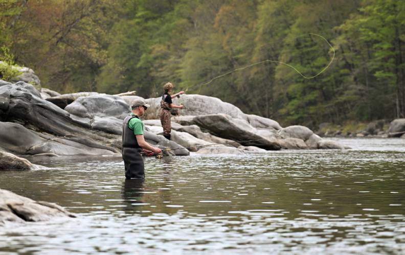 Joel Fiutak, left, and his son Luciano Fiutak, of Boston, do a little fishing in the Deerfield River in Shelburne on Saturday before the rain set in. Joel Fiutak, left, and his son Luciano Fiutak, of Boston, do a little fishing in the Deerfield River in Shelburne on Saturday before the rain set in.