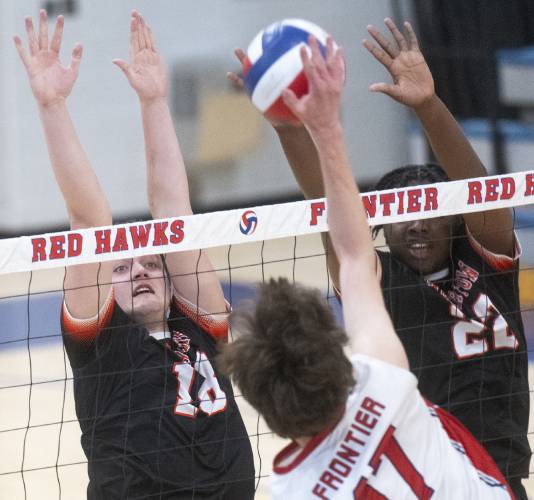 Belchertown's Brian Burns, left, and Gabriel Ibekilo, right, attempt to block a spike from Frontier's Tegan Dexter (17) during a match earlier this season in South Deerfield.