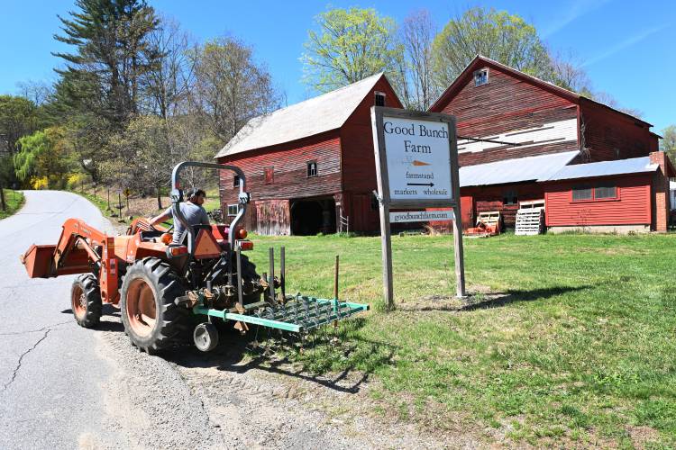 Dan Greene of Good Bunch Farm in Shelburne Falls heads out into his fields on a tractor.