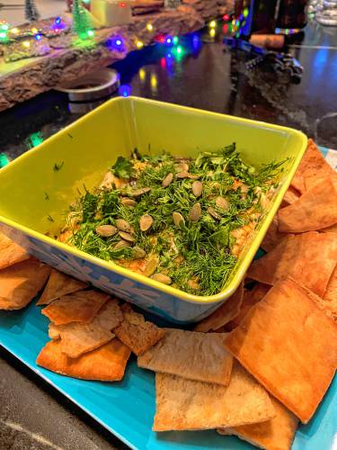 The McCormick Tangy Feta Dip recipe has two different toppings for flavor — a honey glaze and chile flavor profile and a mixture of fresh herbs and nuts.