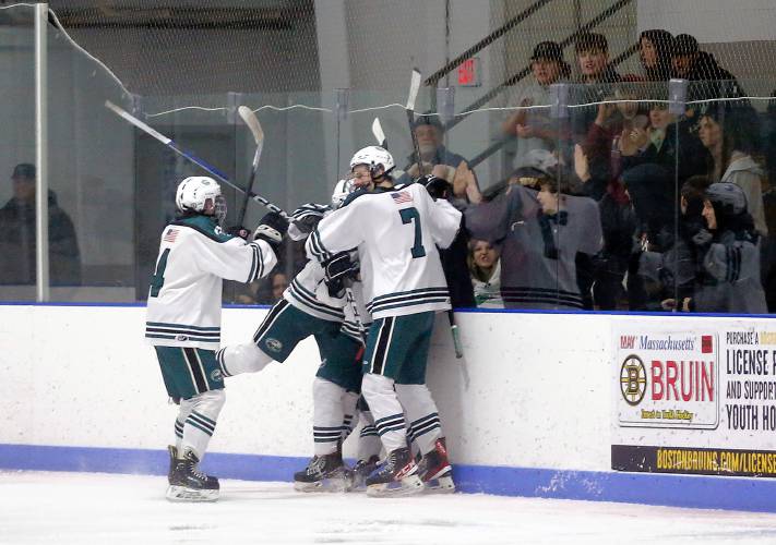 Greenfield players celebrate a second period goal by Jake Jurek (2) against Easthampton on Saturday night at Collins-Moylan Arena in Greenfield.