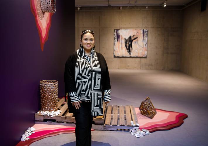 Shinnecock artist Courtney M. Leonard stands for a portrait at her exhibit “BREACH: Logbook 24 | Staccato” on Wednesday at the UMass Museum of Contemporary Art. The exhibit focuses on Staccato, a right whale whose remains came to UMass in 1999.