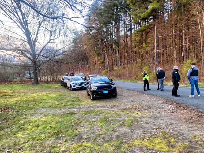 Police search for a cabin in the woods behind Cliffside Apartments in Sunderland, believed to be tied to a homicide on Chapman Street in Greenfield.