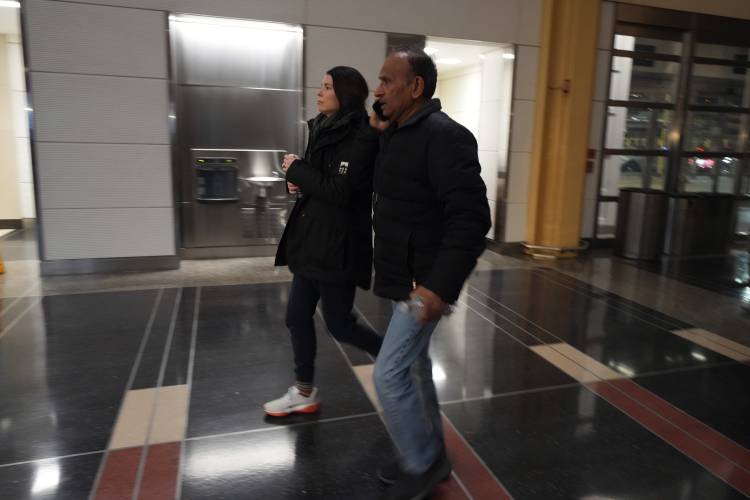 People arrive to check on passengers at Ronald Reagan Washington National Airport, Thursday, Jan. 30, 2025, in Arlington, Va. (AP Photo/Julio Cortez)