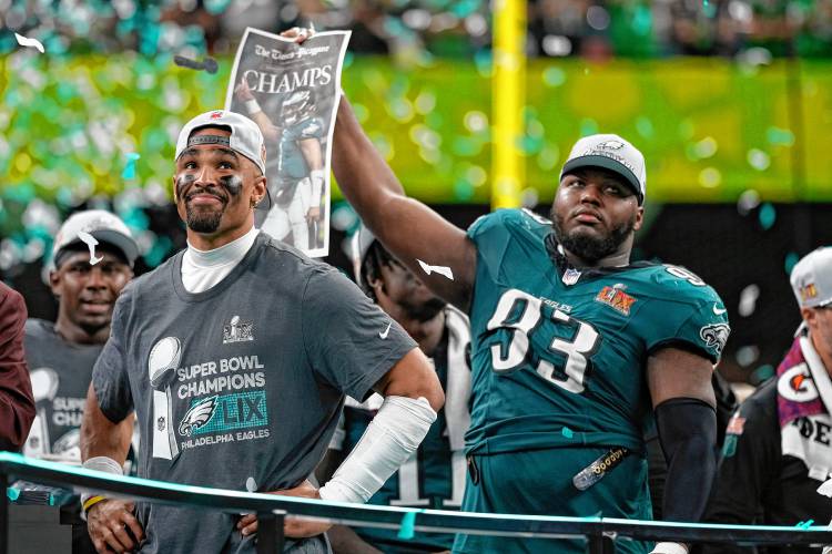 Philadelphia Eagles quarterback Jalen Hurts smiles on the podium next to defensive tackle Milton Williams (93) after a win over the Kansas City Chiefs during Super Bowl 59 on Feb. 9 in New Orleans. Williams signed with the New England Patriots on Monday. Philadelphia Eagles quarterback Jalen Hurts smiles on the podium next to defensive tackle Milton Williams (93) after a win over the Kansas City Chiefs during Super Bowl 59 on Feb. 9 in New Orleans. Williams signed with the New England Patriots on Monday.
