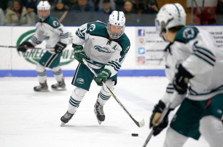 Greenfield’s Matt Garvin (14) sends a pass against Easthampton in the second period Saturday night at Collins-Moylan Arena in Greenfield.