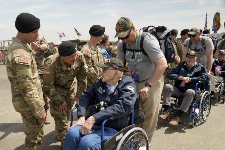 American D-Day veterans are welcomed by U.S. soldiers at Deauville airport, Monday, June 3, 2024 in Deauville, Normandy to attend D-Day 80th anniversary commemorations.
