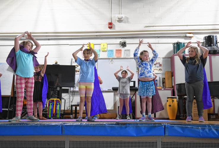 Hawlemont Regional School third graders, with help from some first and second graders, perform “The Weather Friends” musical on Thursday. In the musical, a group of Weather Superheroes respond to weather emergencies around the world and teach people about the water cycle and severe weather.