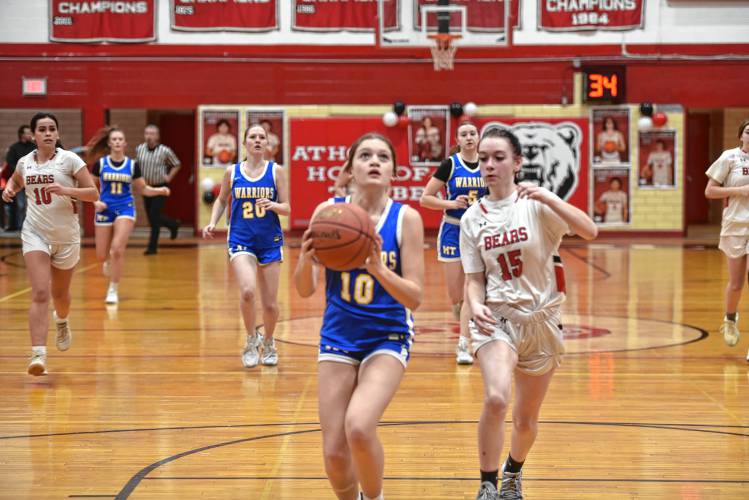 Mohawk Trail's Emmalee Inman takes it to the basket while Athol's Maddie Hermes tries to chase her down on Friday at Mallet Gymnasium in Athol. 