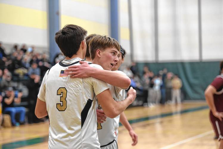 Pioneer's Ben Werner hugs teammate Kurt Redeker after Redeker scored his 1,000th career point on Saturday against Duggan during the Western Mass. Class D championship game at Holyoke Community College. 