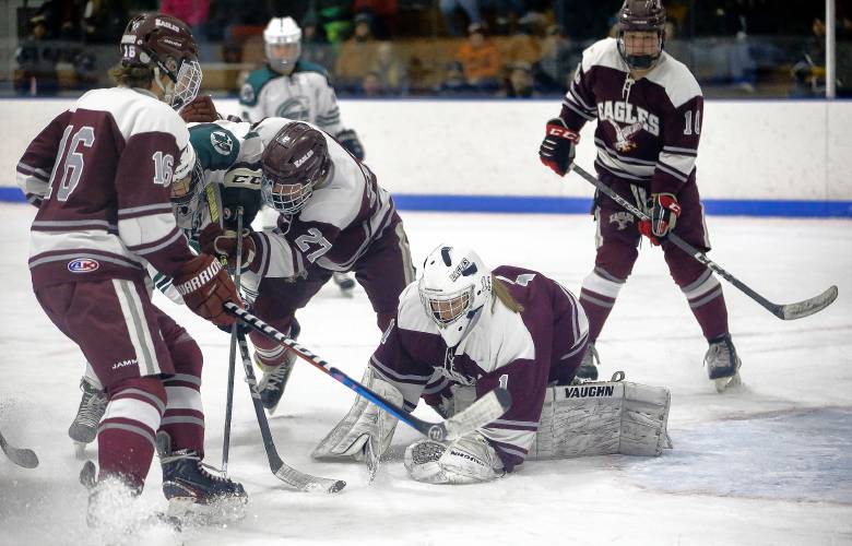 Easthampton goalkeeper Paige Galpin (1) dives on the puck to fend off the attack from Greenfield in the second period Saturday night at Collins-Moylan Arena in Greenfield.