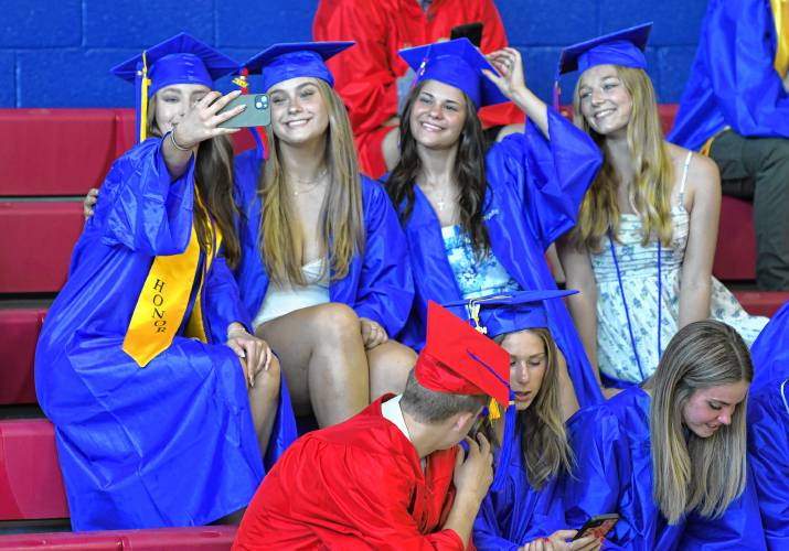 Seniors at Ralph C. Mahar Regional School take a selfie in the gym prior to graduation on Friday in Orange.