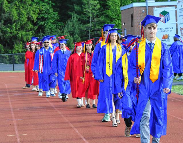 Seniors process onto the athletic field for graduation.
