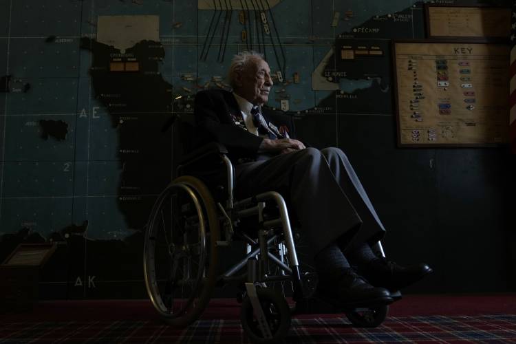 British Normandy campaign veteran Les Underwood of the Royal Navy poses in the ‘Map Room’ which shows the large diagram of the D-Day Invasion, at Southwick army base near Portsmouth, England, Monday, June 3, 2024. Underwood is part of a group of veterans travelling to France for the 80th anniversary commemoration of the D-Day Invasion.
