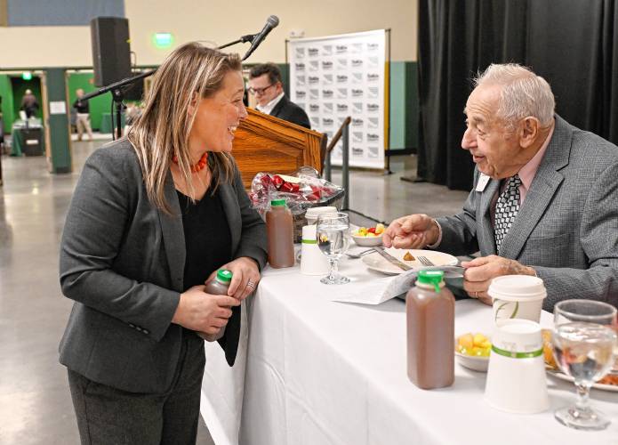 Rep. Natalie Blais talks with this year’s Greenfield Recorder Citizen of the Year Russell Deane at Deerfield Academy on Friday morning during the Franklin County Chamber of Commerce breakfast.