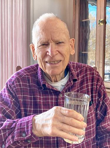 Gerry holding his mealtime glass of water.