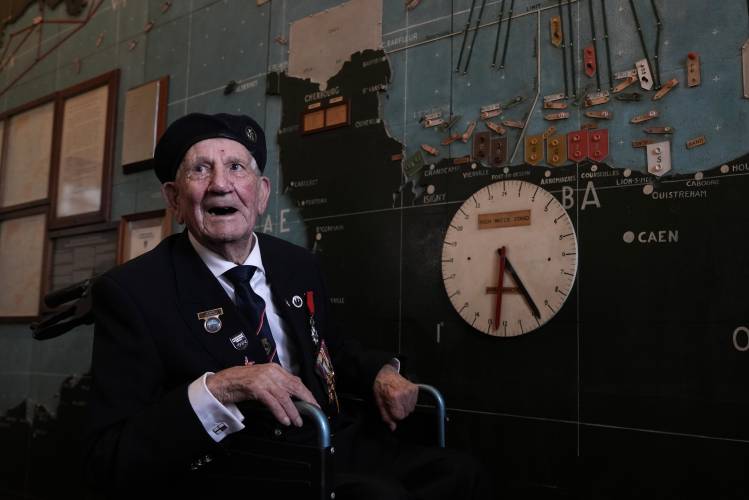 British Normandy campaign veteran George Chandler of the Royal Navy speaks to the media and poses in the ‘Map Room’ which shows the large diagram of the D-Day Invasion, at Southwick army base near Portsmouth, England, Monday, June 3, 2024. Chandler is part of a group of veterans travelling to France for the 80th anniversary commemoration of the D-Day Invasion.