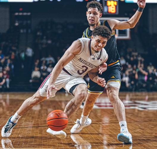 UMass sophomore guard Marqui Worthy (3) drives to the basket against a La Salle defender during the Minutemen’s 82-60 win last Sunday at Mullins Center in Amherst. Worthy has emerged as a key two-way contributor for UMass this season.