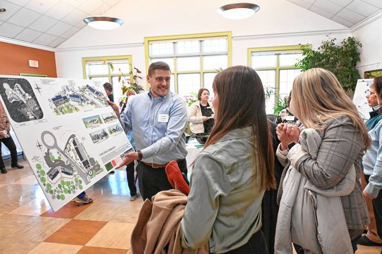 Erving Town Administrator Bryan Smith shows designs for the town’s affordable senior and multi-generational housing project, called Evergreen Circle at Care Drive, to attendees at the Erving Senior and Community Center on Tuesday.