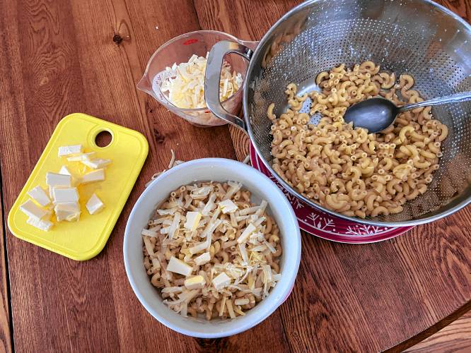 Layering the macaroni, butter and cheese to create Macaroni Pie, a dish created by chef James Hemings in the late 1700s. Hemings, who studied culinary arts in Paris, was enslaved by Thomas Jefferson, and was also his half brother-in-law.