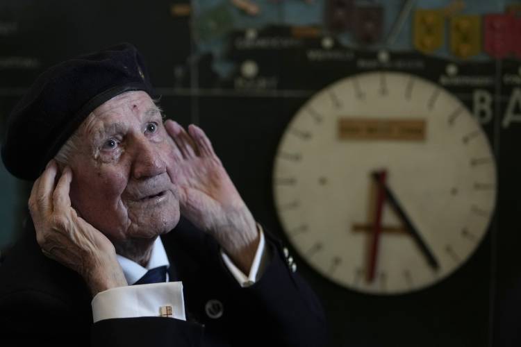 British Normandy campaign veteran George Chandler of the Royal Navy speaks to the media and poses in the ‘Map Room’ which shows the large diagram of the D-Day Invasion, at Southwick army base near Portsmouth, England, Monday, June 3, 2024. Chandler is part of a group of veterans travelling to France for the 80th anniversary commemoration of the D-Day Invasion.