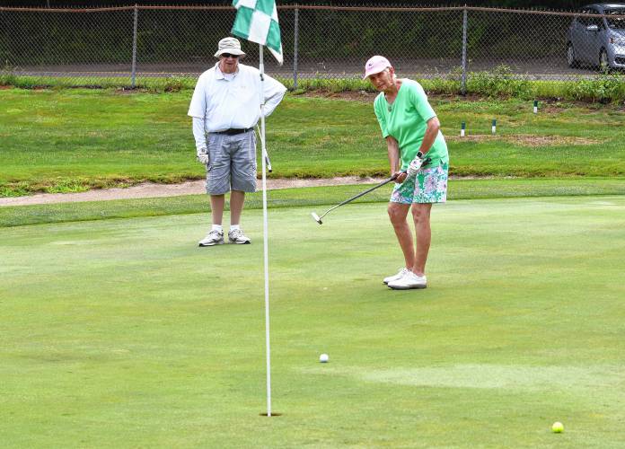 Richard “Rock” Rockstroh watches partner Susan McDonald putt on the first hole at the Country Club of Greenfield during 18-Hole Women’s League play on Tuesday.