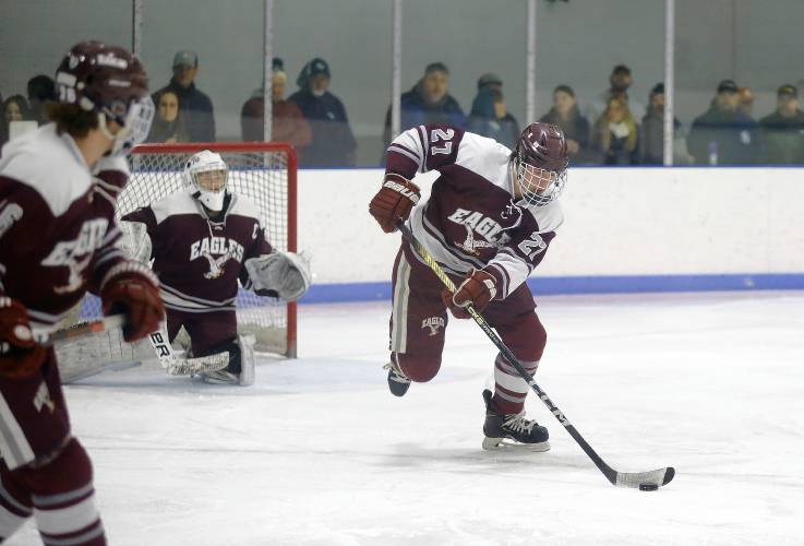 Easthampton’s Brett Baranowski (27) clears the puck out against Greenfield in the second period Saturday night at Collins-Moylan Arena in Greenfield.