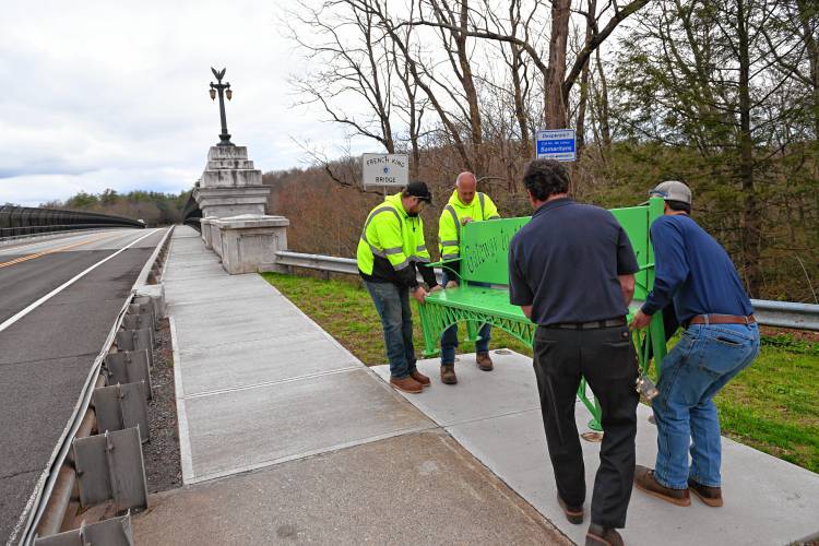 Franklin County Technical School senior Laynie Coates’ bench is installed on the Erving side of the French King Bridge on Monday.