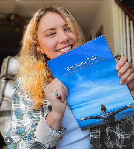 Carly Rae Brunault holds a copy of her book, “Trail Name Tales.” She underwent an Appalachian Trail hike as a way of coping with the loss of her longtime partner, also an avid hiker, who died at the age of 26 after his struggles with addiction.