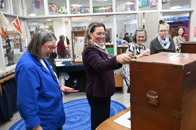 State Representative Natalie Blais, center, checks out an old vote tallying machine on display in “Voices and Votes: Democracy in America,” currently on display in the library at the Mohawk Trail Regional School in Buckland.