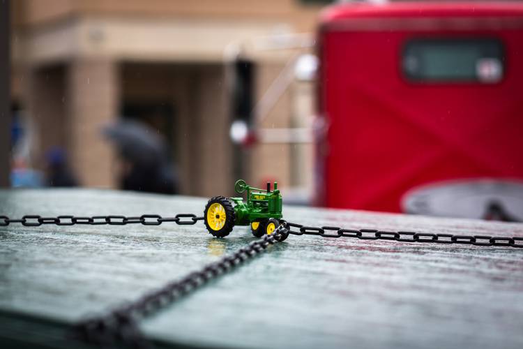 A miniature John Deere tractor on the flatbed of one of the classic trucks at the antique truck show at Yankee Candle Corporate Headquarters in South Deerfield.