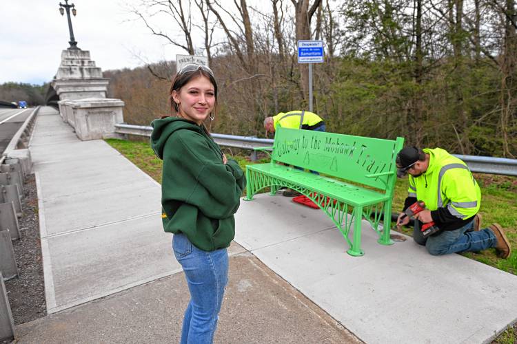 Franklin County Technical School senior Laynie Coates watches as the bench she made in the welding and metal fabrication lab for her capstone project is installed at the French King Bridge in Erving on Monday.