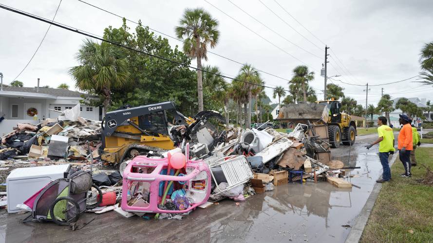 Salvage works remove debris from Hurricane Helene flooding along the Gulf of Mexico before approaching Milton, Monday, Oct. 7, 2024, in Clearwater Beach, Fla.