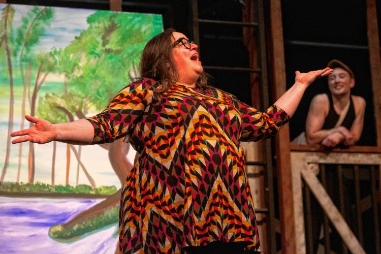 Kimberly Karlin, as Medda Larkin, sings “That’s Rich” while Greyson Lynch, as Jack Kelly, watches.