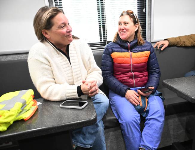 State Rep. Natalie Blais and Kristen Elechko, western Massachusetts director for the Governor’s Office, coordinate with officials in the National Grid Mobile Command Center parked in the Berkshire East Mountain Resort parking lot in Charlemont on Tuesday. 