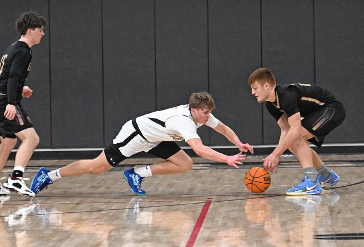 Pioneer’s Jackson Glazier goes to the floor for a loose ball with Old Colony’s Nick Fringuelli during the top-seeded Panthers’ victory in the MIAA Division 5 Round of 16 on Tuesday at Messer Gymnasium in Northfield. 