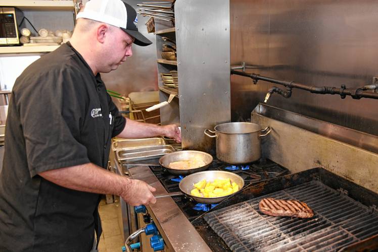 David Comstock, executive chef at Berkshire East Mountain Resort, prepares chicken piccata and a classic strip steak.