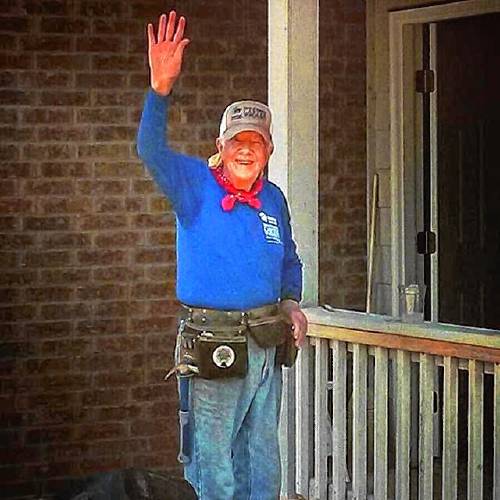 Former President Jimmy Carter waves during a Habitat for Humanity building project. 
