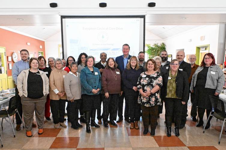 State and local officials pose for a group photo after a meeting outlining plans for Evergreen Circle at Care Drive, a senior and multi-generational housing project planned in Erving.