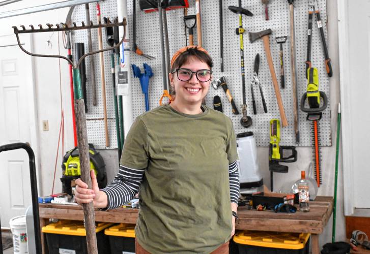 Syd St. John with gardening tools in their Highland Avenue garage in Greenfield. St. John plans to start a flower business called Nettlepoint Farm.