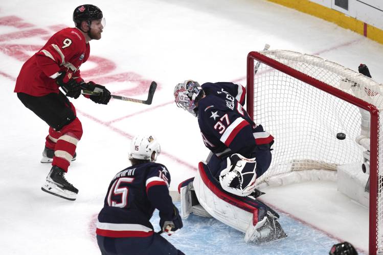 Canada's Sam Bennett (9) scores on United States goalie Connor Hellebuyck during the second period of the 4 Nations Face-Off championship hockey game, Thursday, Feb. 20, 2025, in Boston. (AP Photo/Charles Krupa)