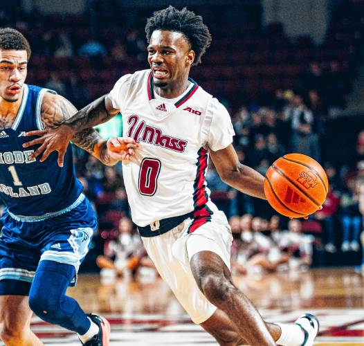 UMass guard Jaylen Curry (0) drives to the basket on Rhode Island defender Sebastian Thomas (1) during the first half of the Minutemen’s 91-88 win on Saturday night at Mullins Center in Amherst.