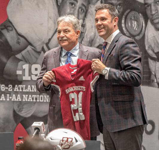 UMass football coach Don Brown, left, is presented a Minuteman jersey by UMass Amherst Director of Athletics Ryan Bamford during a press conference at his introduction in the Martin Jacobson Football Performance Center on Dec. 1, 2021. UMass football coach Don Brown, left, is presented a Minuteman jersey by UMass Amherst Director of Athletics Ryan Bamford during a press conference at his introduction in the Martin Jacobson Football Performance Center on Dec. 1, 2021.