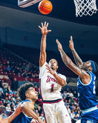 UMass forward Daniel Hankins-Sanford (1) goes up for a shot over two Rhode Island defenders during the first half of the Minutemen’s 91-88 win on Saturday night at Mullins Center in Amherst.