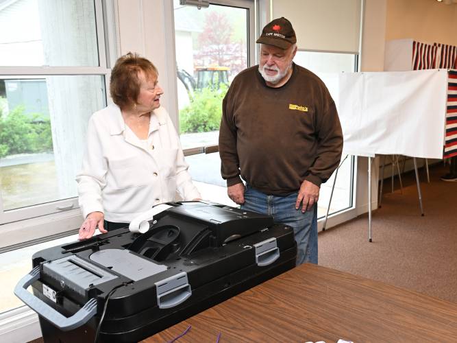 Election worker Pamela Bouthillier registers the ballot of John Zilinski in Erving Town Hall on Monday.